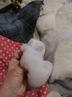 Stuffing from a pillow being fluffed up.
