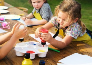 Two young girls getting ready to paint a picture.