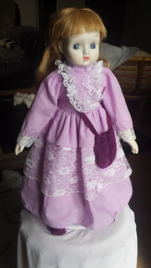 Identifying a Porcelain Doll - red haired doll wearing a purplish pink dress