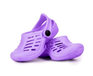 Purple Crocs shoes on white background