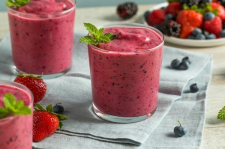 Berry Smoothie with blueberries and strawberries in the  background