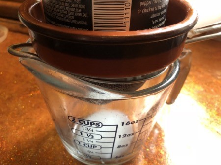 Yogurt in strainer with weight on top