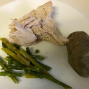 cooked turkey on plate with asparagus
