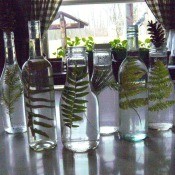 Pretty Botanical Centerpieces - glass bottles with fern fronds