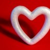 Styrofoam heart wreath on a red background.