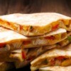 Pan Fried Chicken Quesadilla slices stacked on a plate