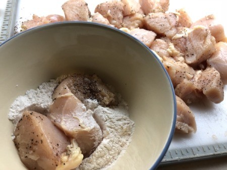 floured Chicken Breast chunks in bowl