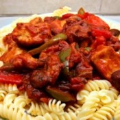 Chicken Breast Cacciatore over pasta on plate