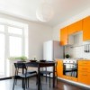 Bright kitchen with orange cabinets.