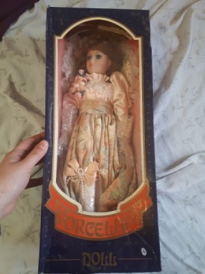 Identifying a Porcelain Doll - doll wearing a pink and floral satin dress