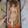 Identifying a Porcelain Doll - doll wearing a pink and floral satin dress