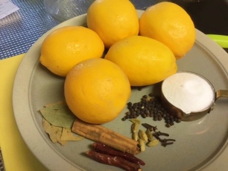 Lemons and spices on plate