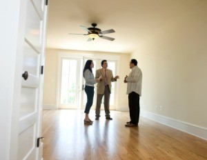 Couple speaking with property manger about renting a house