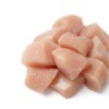 Cubed raw chicken on a white background