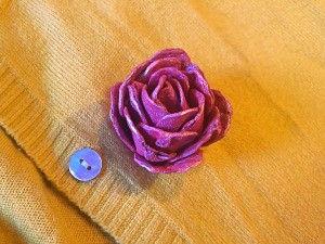 Egg Carton Rose Brooch - brooch on the front of a yellow cardigan