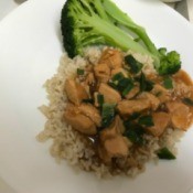 Orange Chicken on rice with broccoli on plate