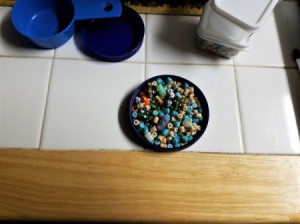 Beads in a recycled lid.