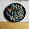 Beads in a recycled lid.