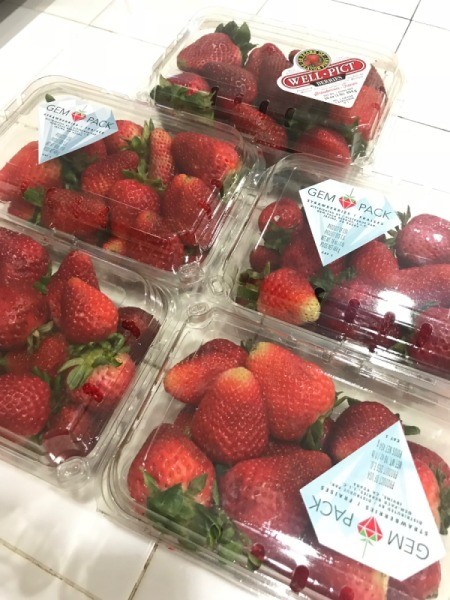Containers of strawberries in clamshell containers.