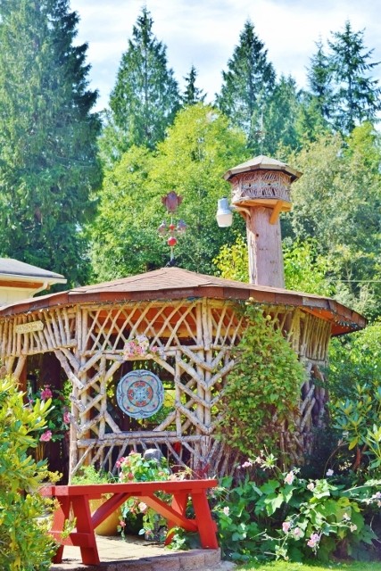 A wooden gazebo in a backyard