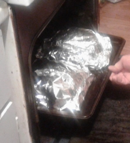 putting Foiled Meat in oven