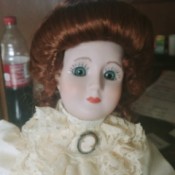 Identifying a Porcelain Doll - period doll with lace ruffle and cameo