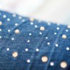 Close up of rhinestone embellished jeans.