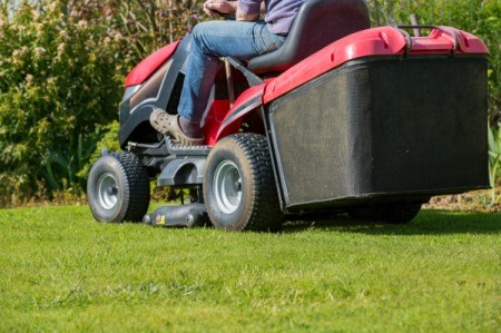Mowing the lawn with tractor mower.