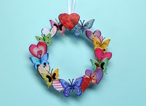 Making a Mini Wreath with Stickers - wreath hanging against a blue background