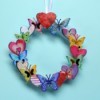 Making a Mini Wreath with Stickers - wreath hanging against a blue background