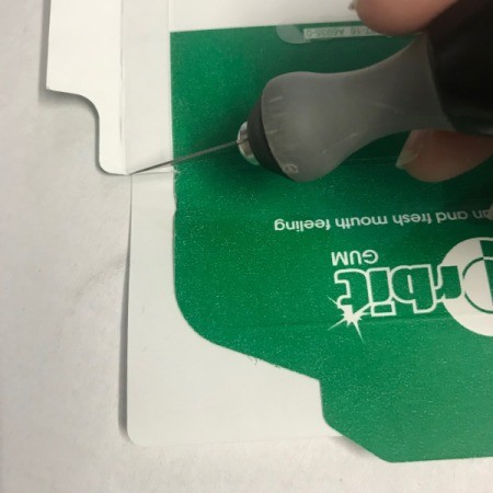 Upcycled Business Card Holder from Gum Packaging - using knife to cut to fit