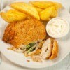 Chicken Kiev on a plate with fries.