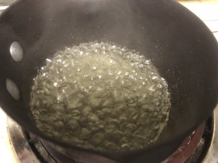 water and sugar in pan making caramel