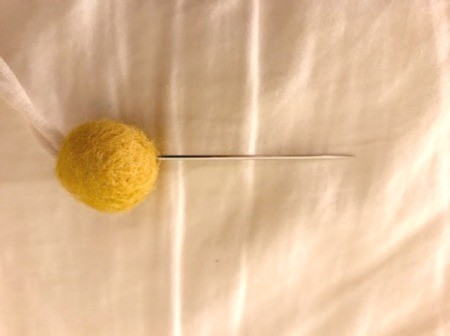 Toddler Felt Ball Necklace - now thread the yard through the enlarge hole