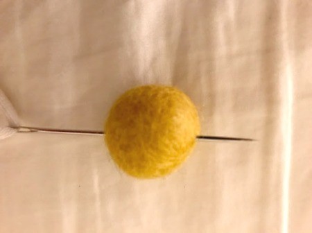 Toddler Felt Ball Necklace - start the hole in the felt ball with the needle