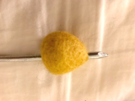 Toddler Felt Ball Necklace - pushing a nail through the hole