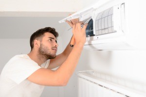 Man doing maintenance on his air conditioner