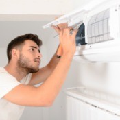 Man doing maintenance on his air conditioner