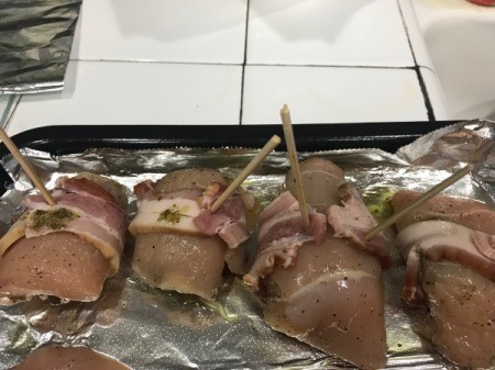 foil lined pan with bacon wrapped chicken