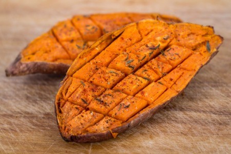 Baked sweet potato cut into cubes with in the skin.