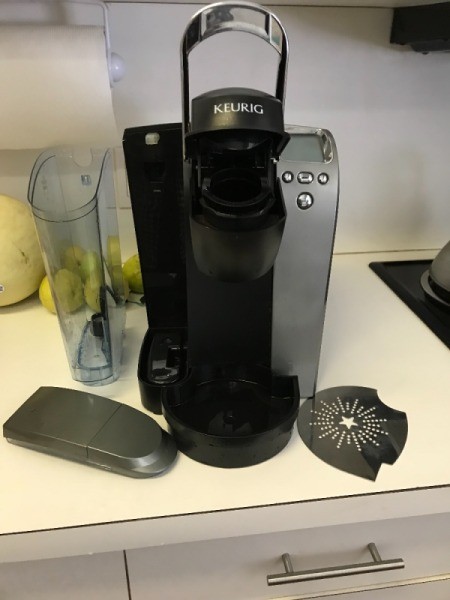 A preowned Keurig coffee maker in a kitchen.