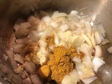 butter, onion and curry powder in pan