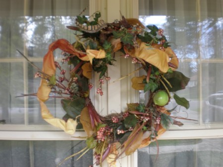 A decorative wreath on a glass window.
