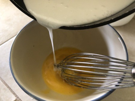 pouring custard into egg