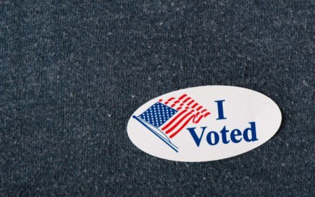 "I Voted" sticker on a navy sweater.