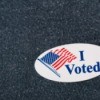 "I Voted" sticker on a navy sweater.