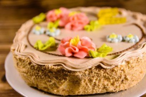 Kiev cake with light brown cream on wooden table