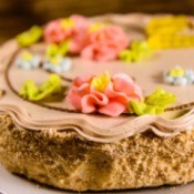 Kiev cake with light brown cream on wooden table
