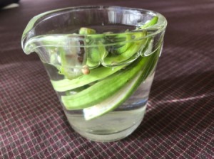 Okra soaking in a measuring cup of water.