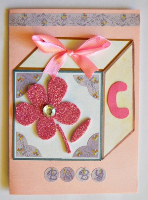 Baby's Toy Cube Card - glue rhinestone to center of flower and add a strip of washi tape to the top and trim ends